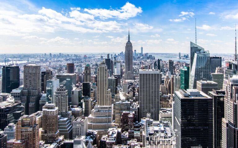 New York City aerial view with the Empire State Building, blue sky, white clouds, Hudson River